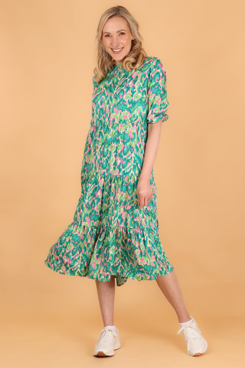 green abstract print tiered midi dress with elbow length sleeves and a loose fitting design