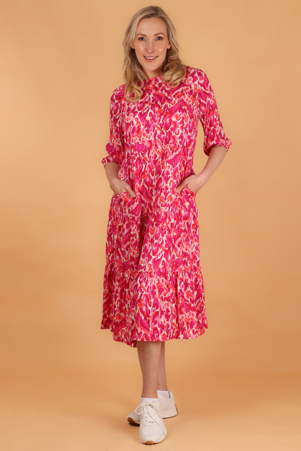 model showing that this classic tiered dress has side pockets