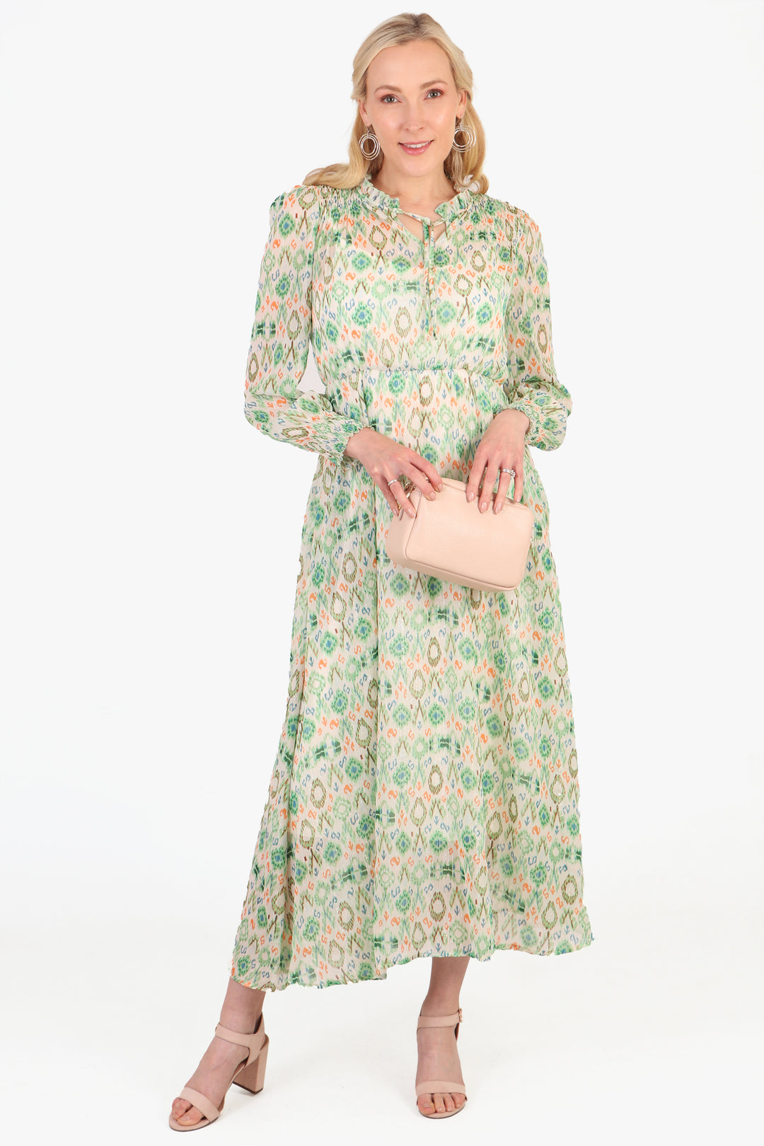 model wearing a long sleeve green dress with an ikat pattern, grandad collar and front tie