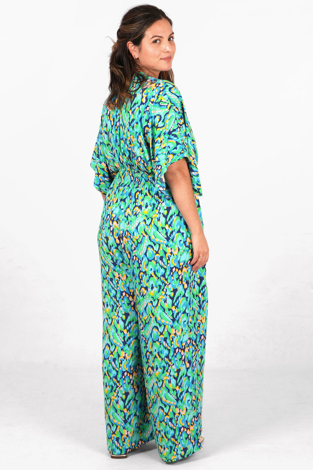 model showing the back of the jumpsuit, showing an all over pattern