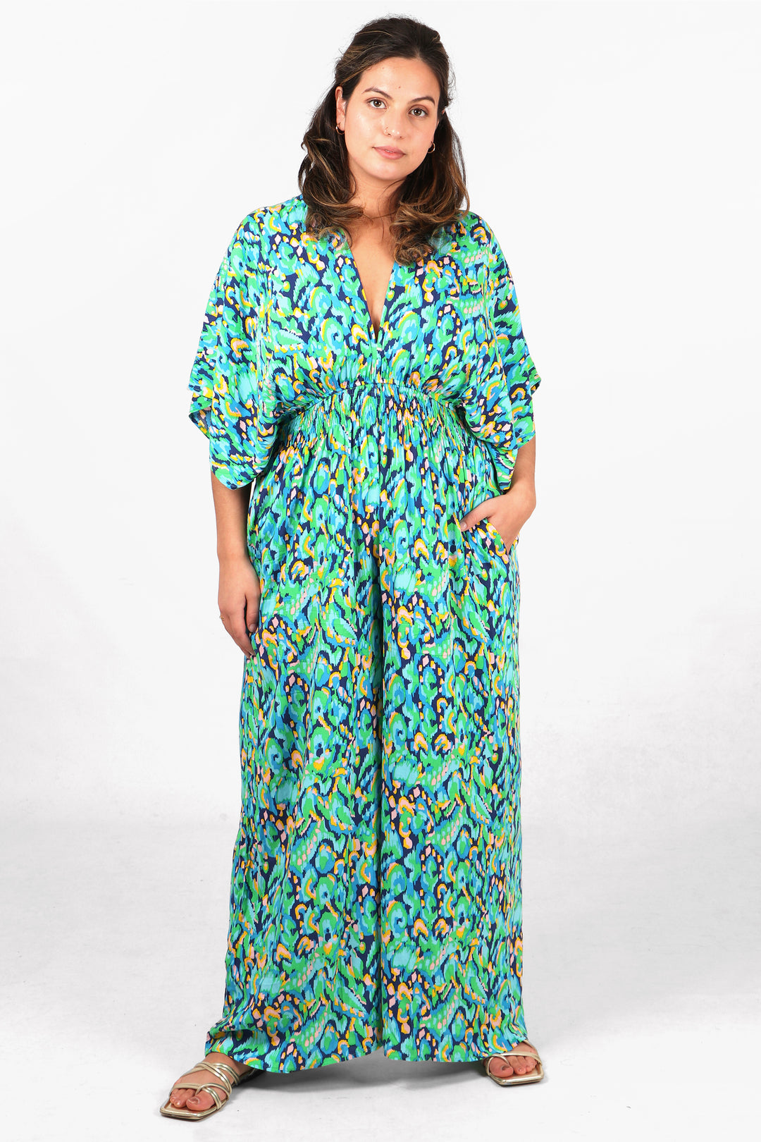 model showing that this green jumpsuit has pockets
