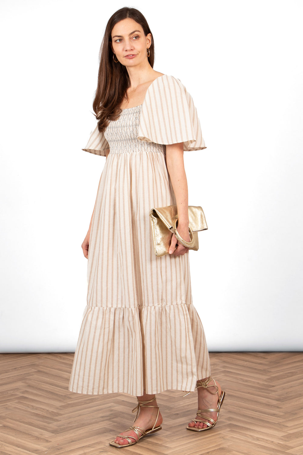 briar-milkmaid-maxi-dress-cream-striped-accessorised-with-gold-sandals-gold-bag