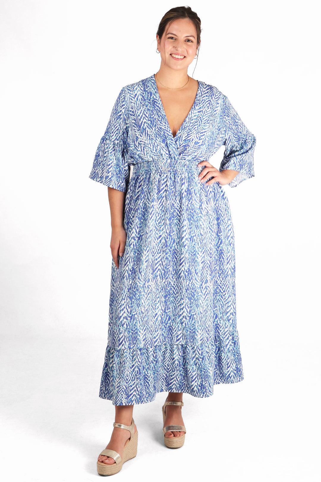 model wearing a blue painted chevron print fluted sleeve shirred maxi dress with v neck