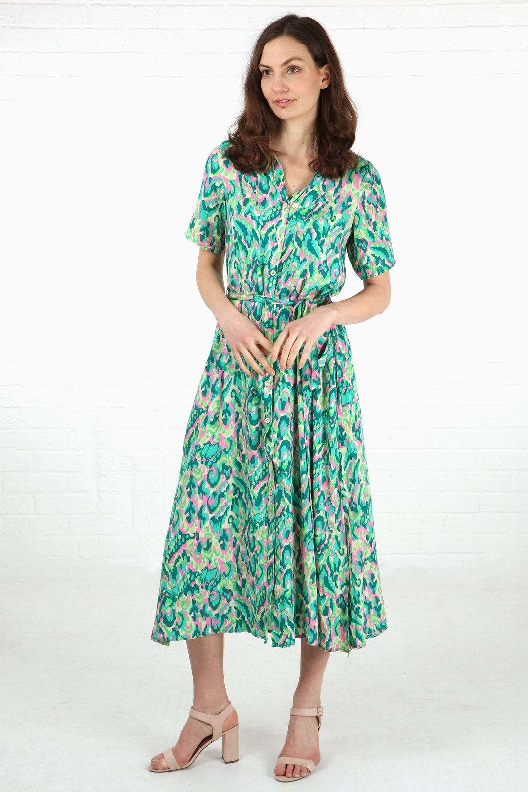 model wearing a green and pink abstract pattern short sleeve shirt dress