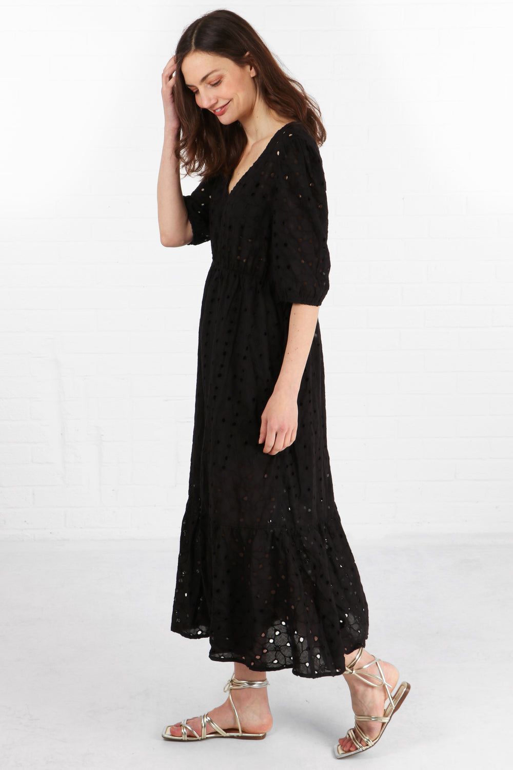 model wearing a black summer cotton midaxi dress with a broderie anglaise pattern material