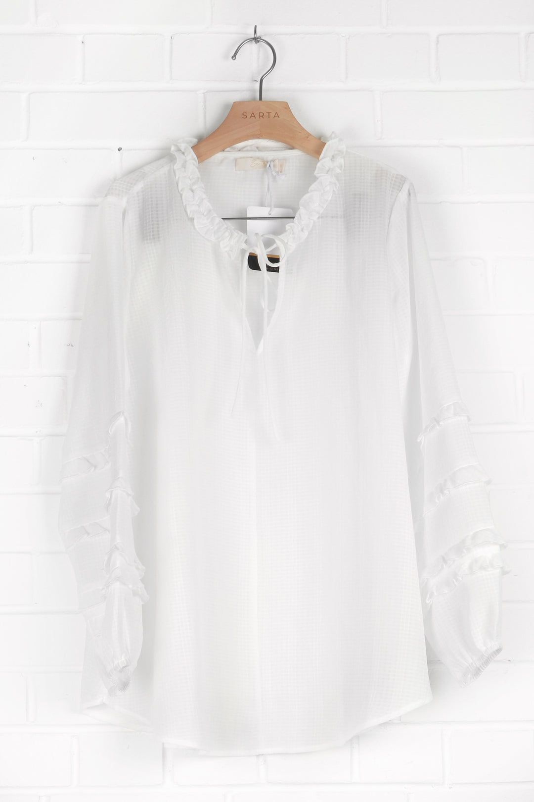 lightweight white blouse with long frill sleeves and a grandad collar