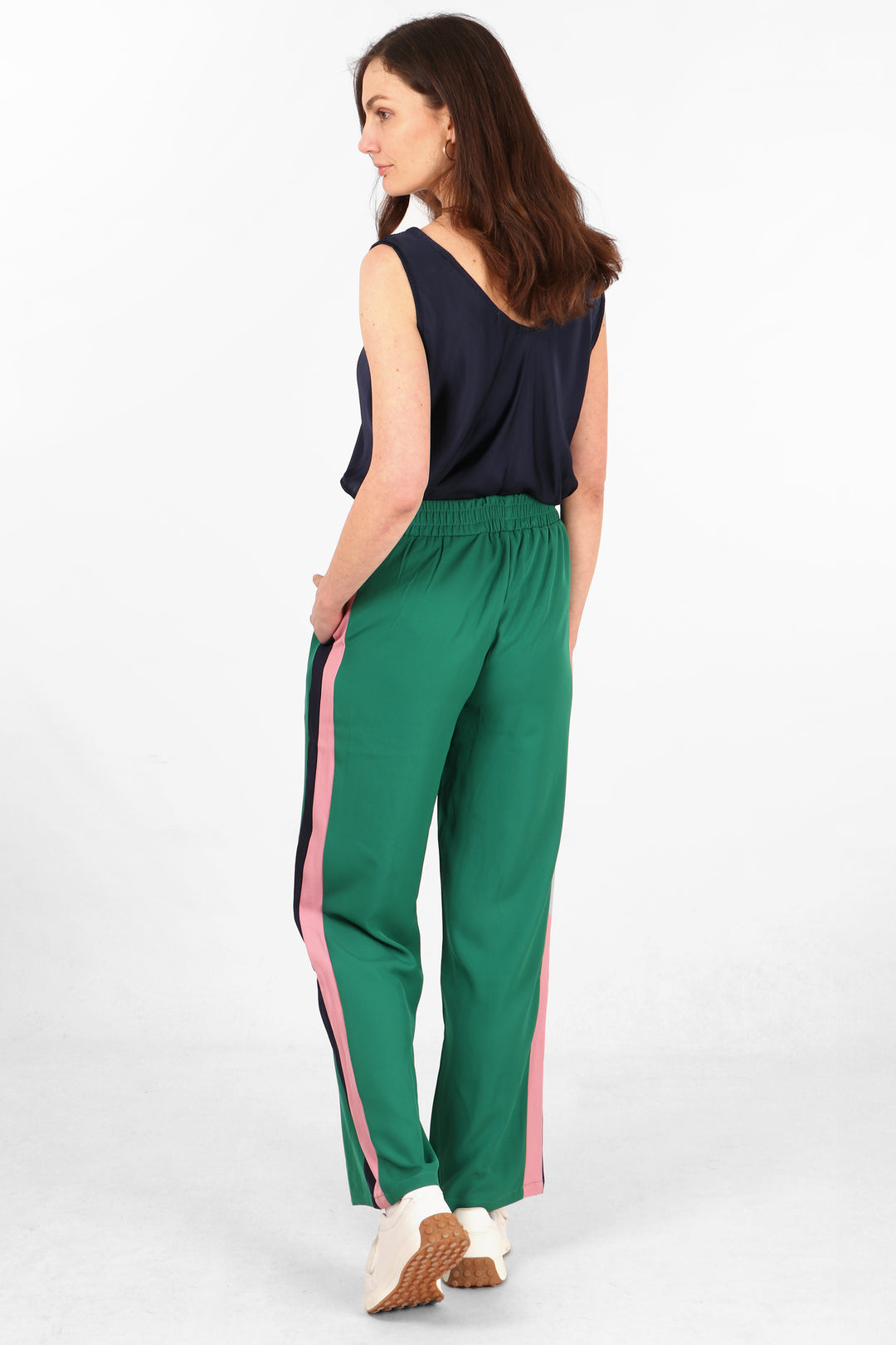 model showing the back of the green trousers, showing the stripes on both sides 