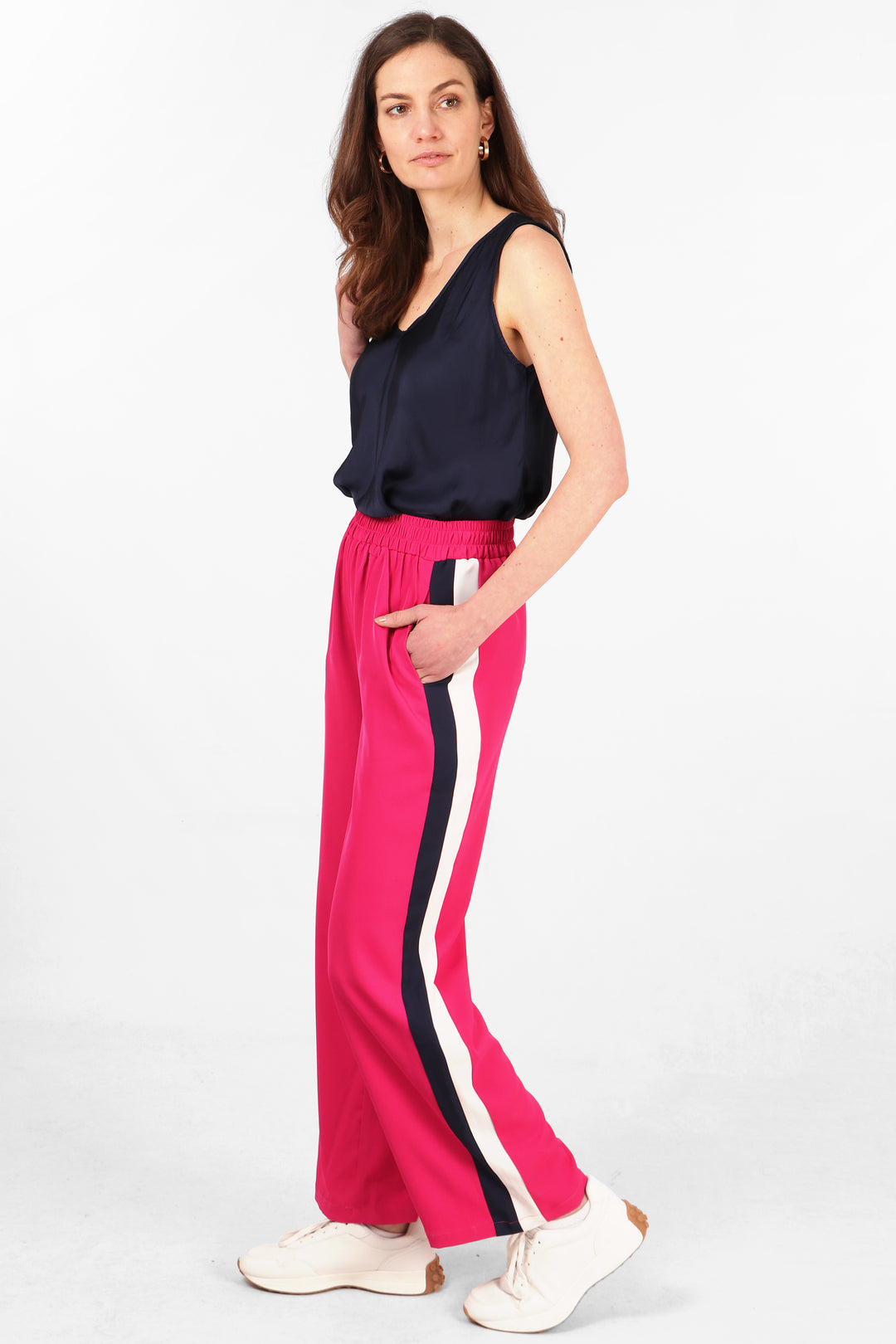 pink casual trousers with pockets, elastcated waist and navy and white stripe on the leg