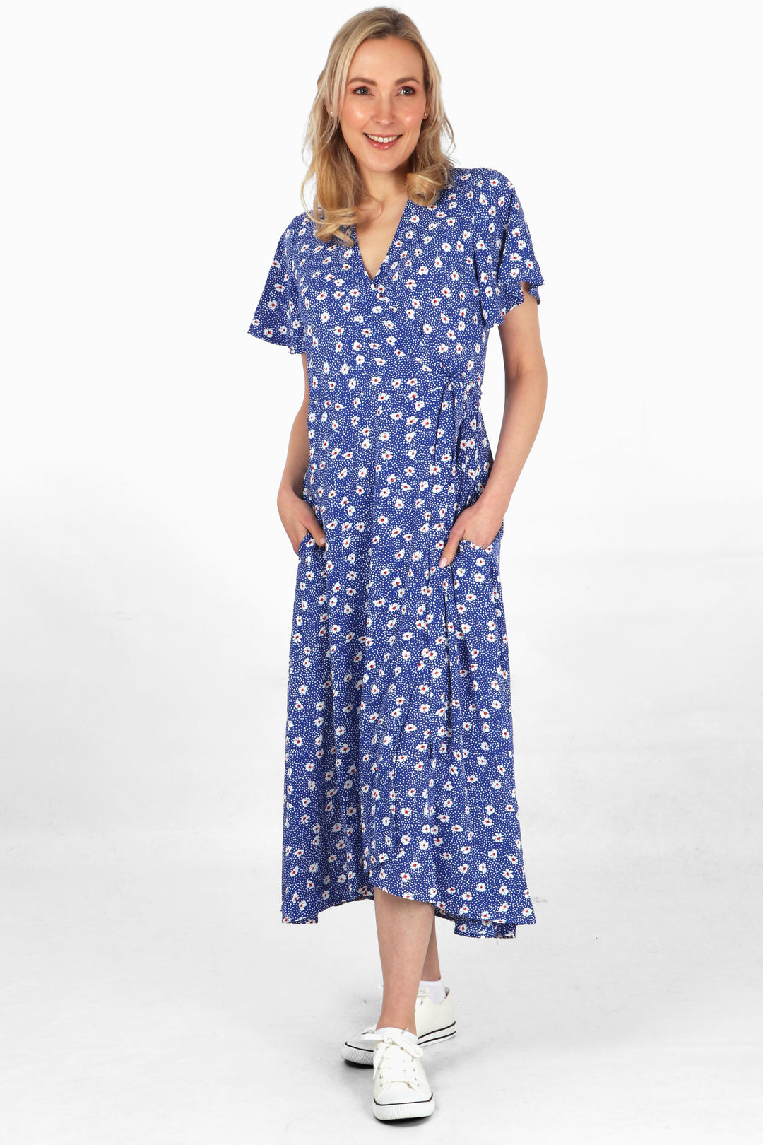 model wearing a blue daisy and spot print short sleeve wrap dress