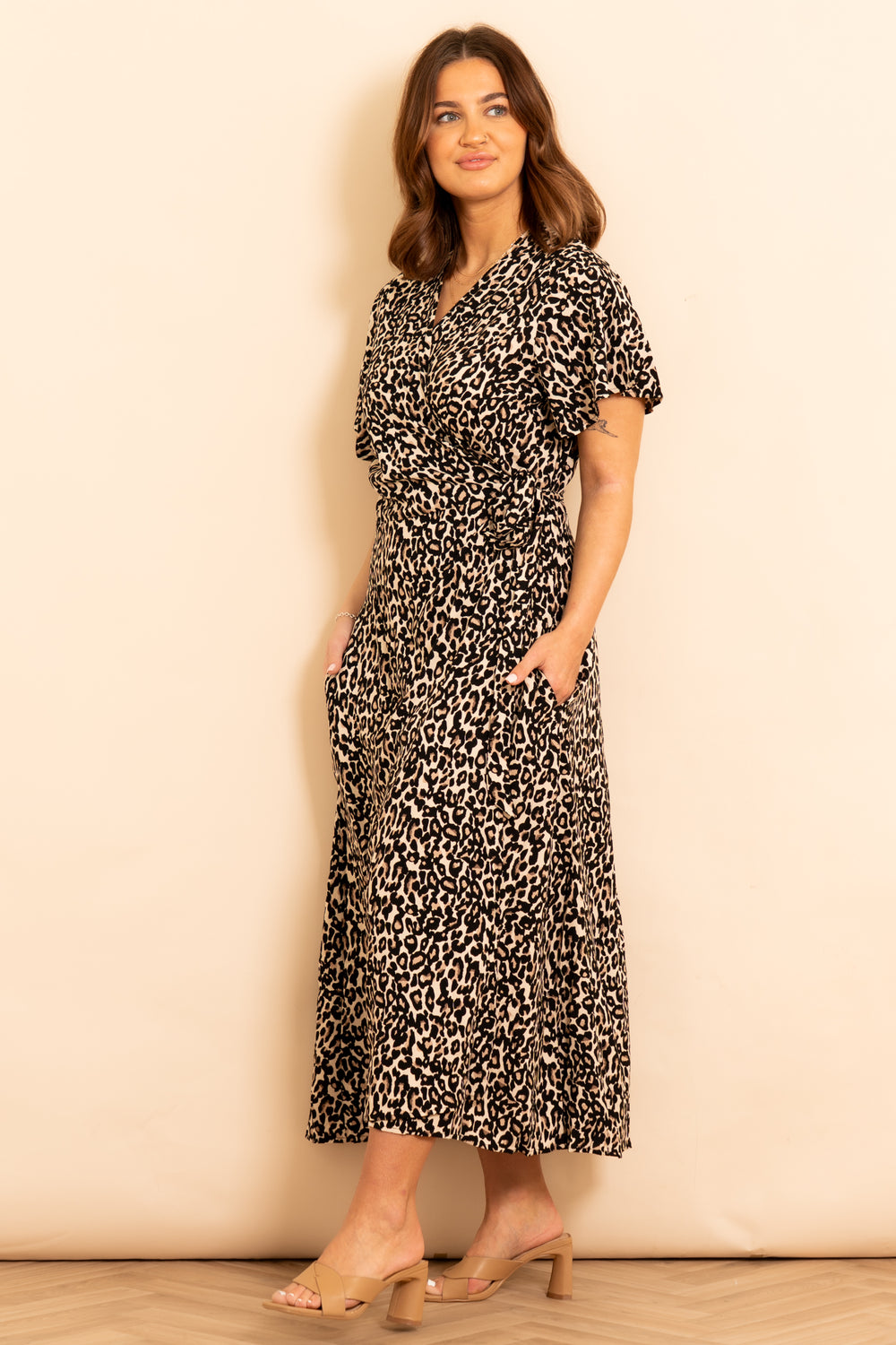 addie-short-sleeve-wrap-dress-neutral-leopard-print-model-showing-side-pockets