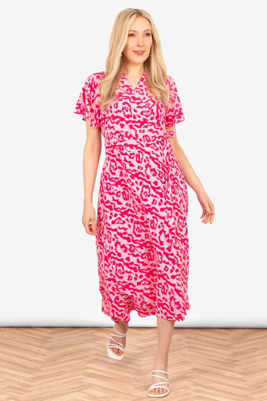 addie-short-sleeve-wrap-dress-pink-animal-print-on-model-front-view-two-tone-print