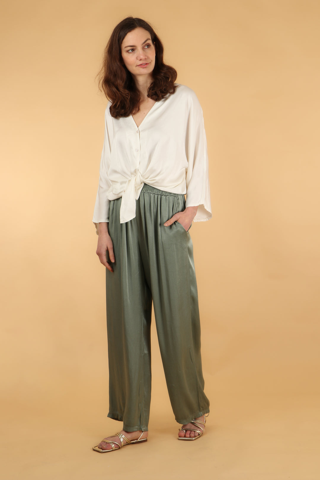 model showing that the long wide leg trousers have pockets for convenience