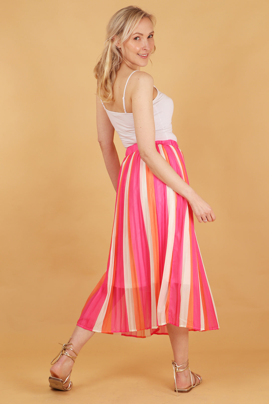 model showing the back of the pleated skirt showing the midi length and all over striped pattern