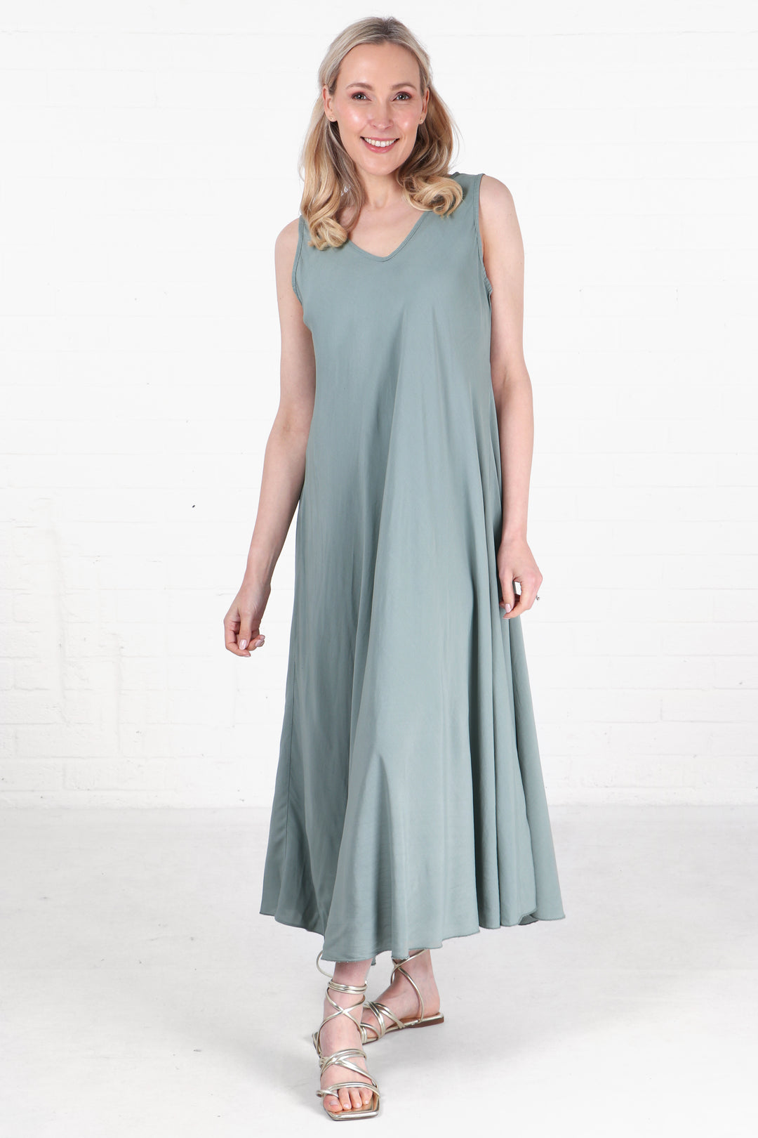 model wearing a sage green summer maxi dress with v neck and a loose fitting aline shape