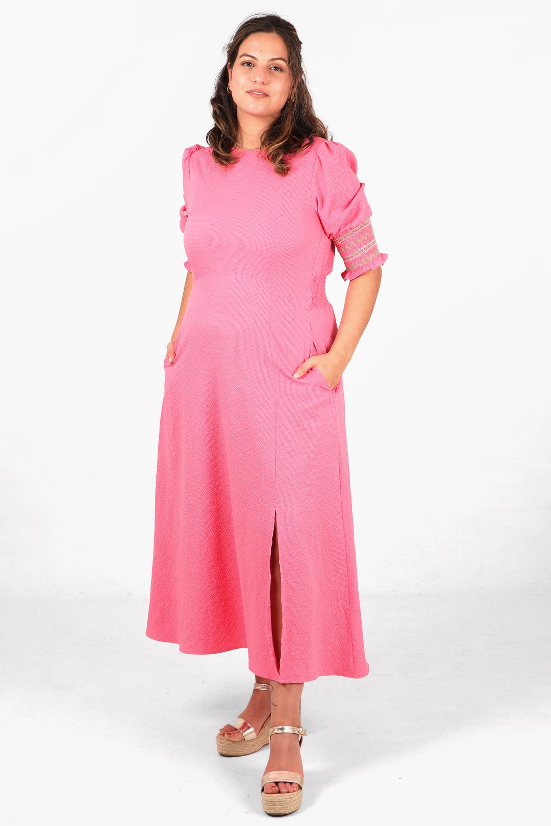 model showing that this pink textured tea dress has pockets