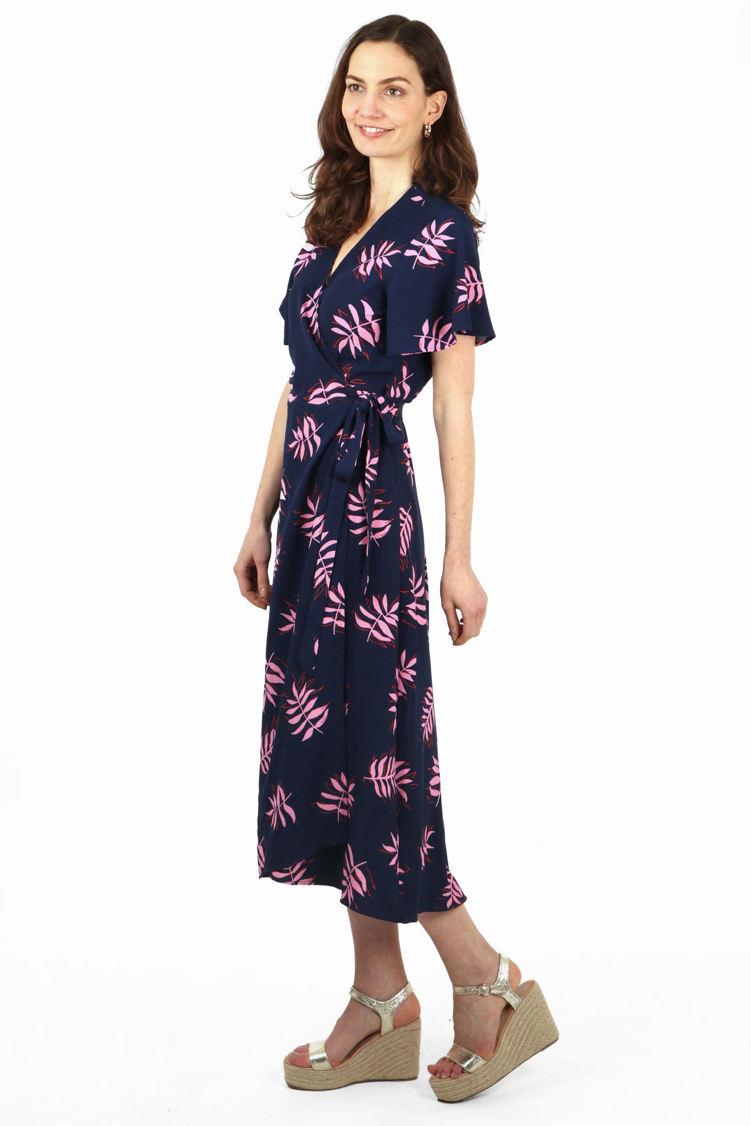 side view of the maxi wrap dress, showing the dip hem and waist tie