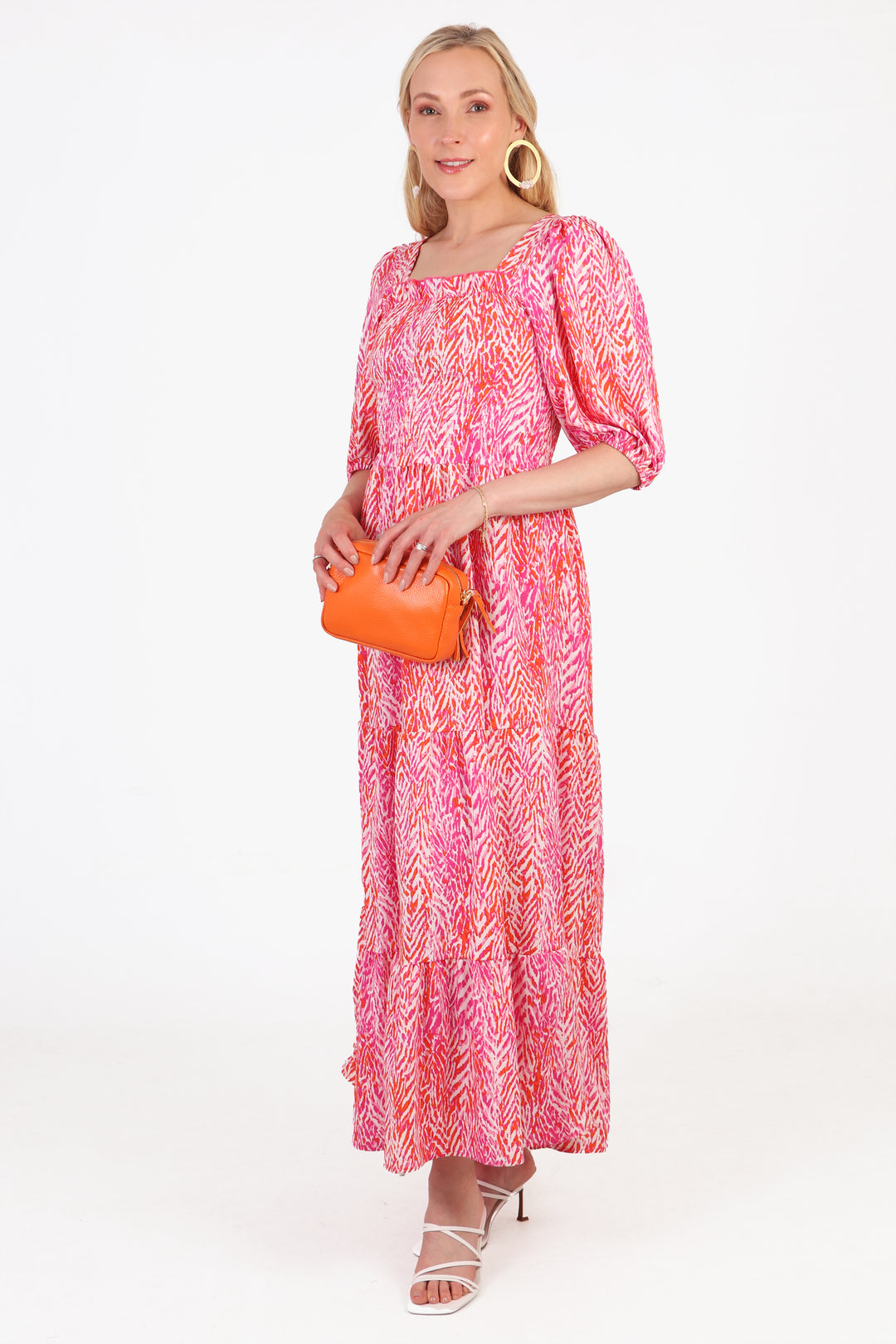 model showing the 3/4 puff sleeve an square neck on the pink maxi dress