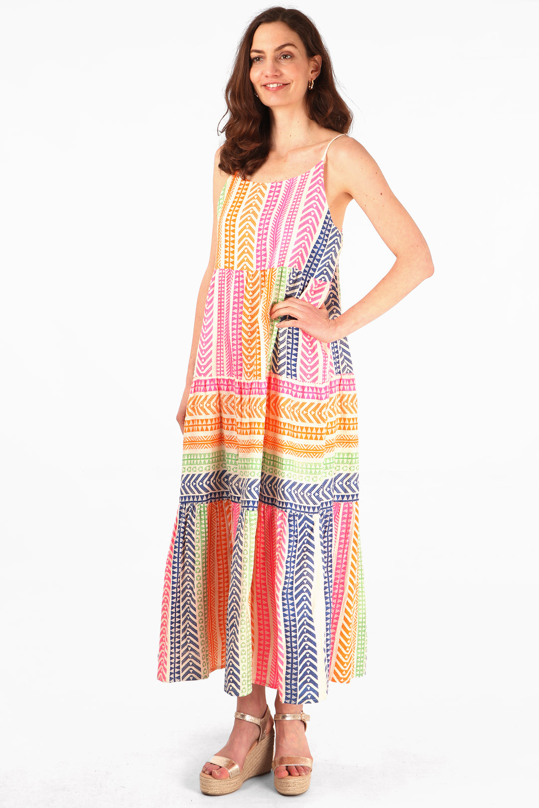 model wearing a muticoloured striped aztec pring tiered maxi dress with spaghetti straps