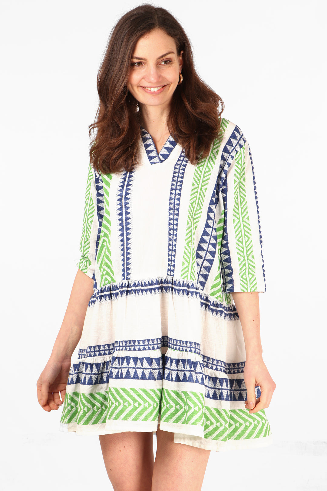 model wearing a green and blue aztec pattern mini dress with v neck and 3/4 sleeves