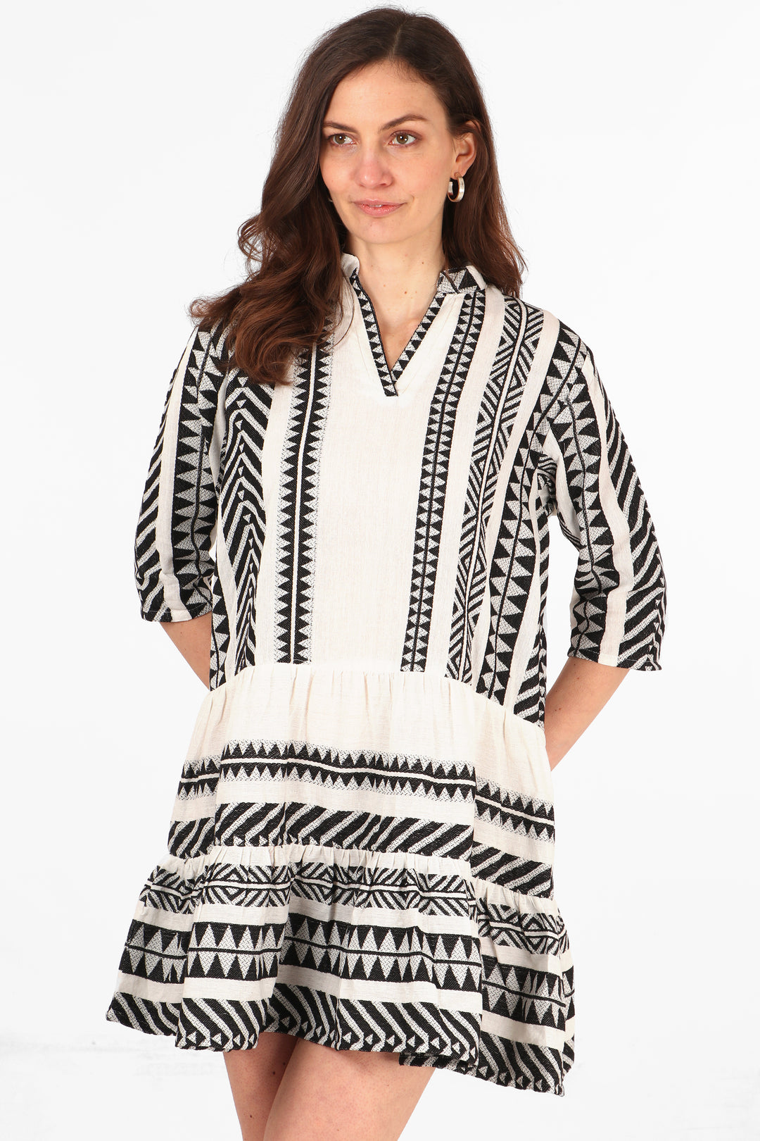 model wearing a black and white midi dress with an aztec print pattern and 3/4 sleeves