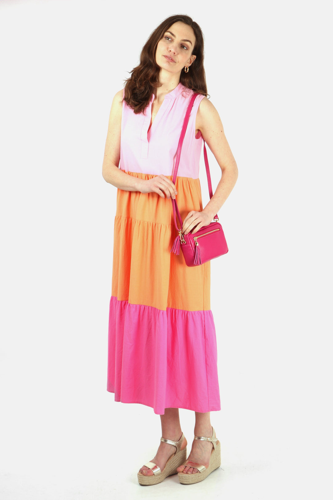 model wearing this pink striped dress with wedge sandals and a pink leather bag to accessorise