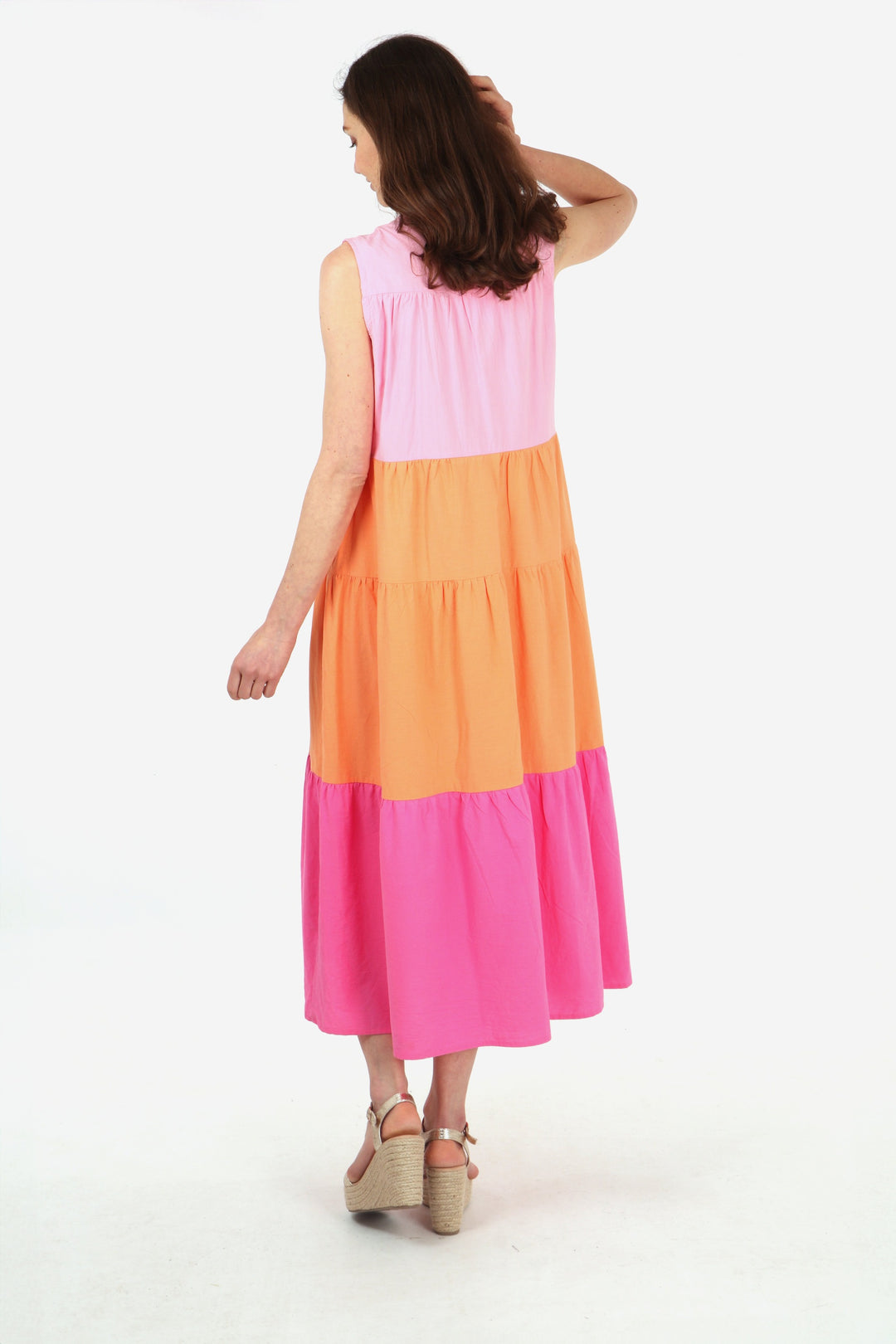 model showing the back of the sleeveless dress showing an all over colour block stripe pattern