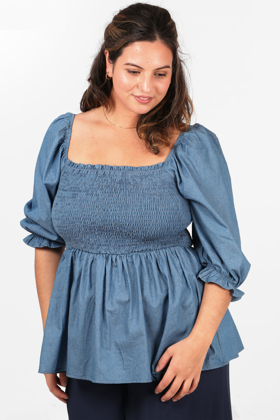 blue milkmaid style top in denim blue with a shirred bodice and 3/4 sleeves