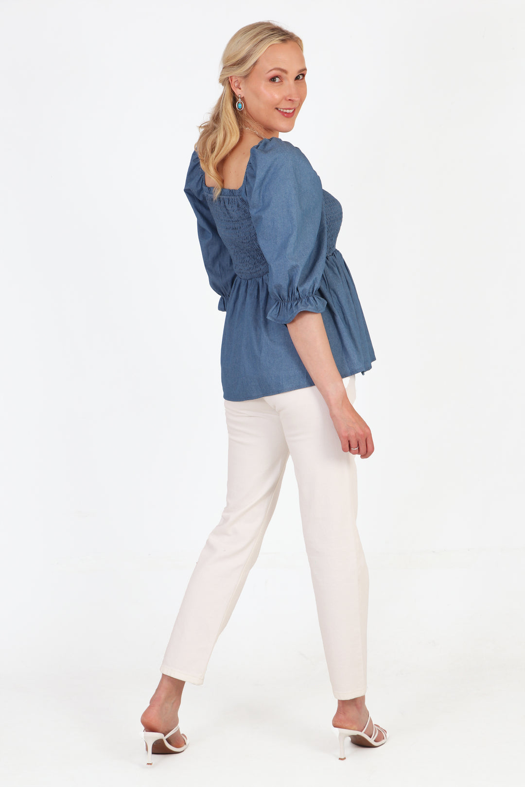 model showing the back of the blouse, showing that the hemline sits on the hips