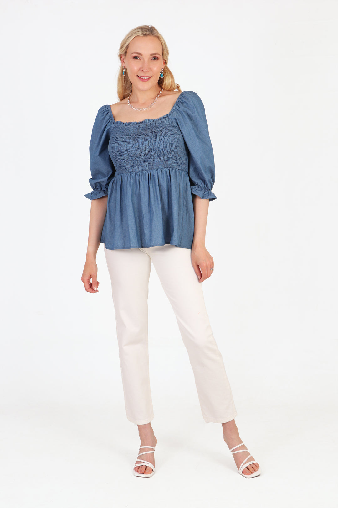 denim blue peplum milkmaid blouse paired with white trousers and sandals for a summer look