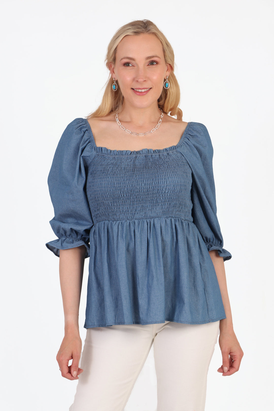 model wearing a square neck plain blue peplum blouse with a shirred bodice