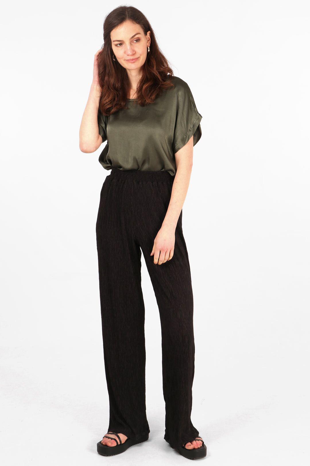 model wearing long black summer plisse trousers with an elasticated smocked waist