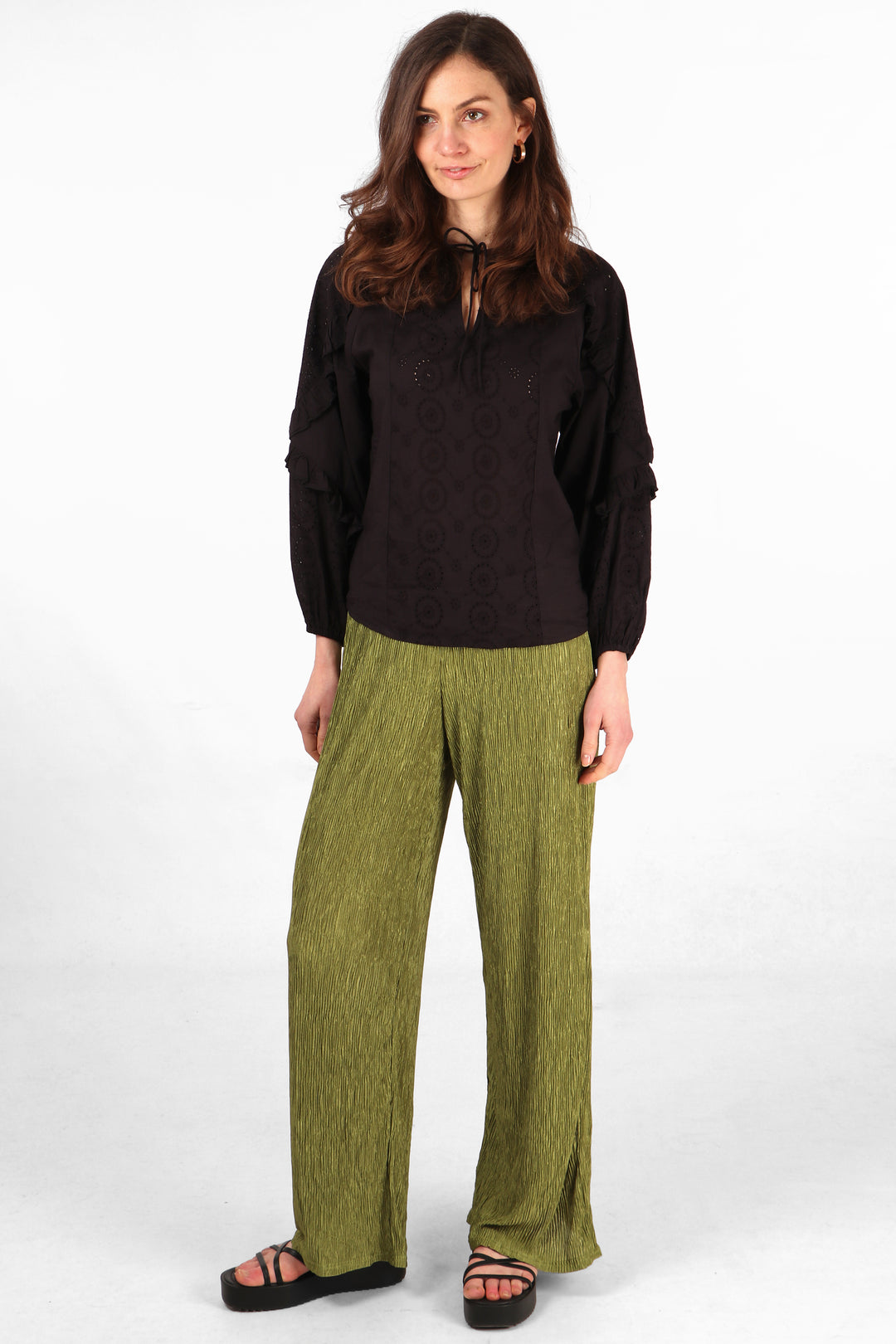 model wearing crinkled plisse olive green summer trousers