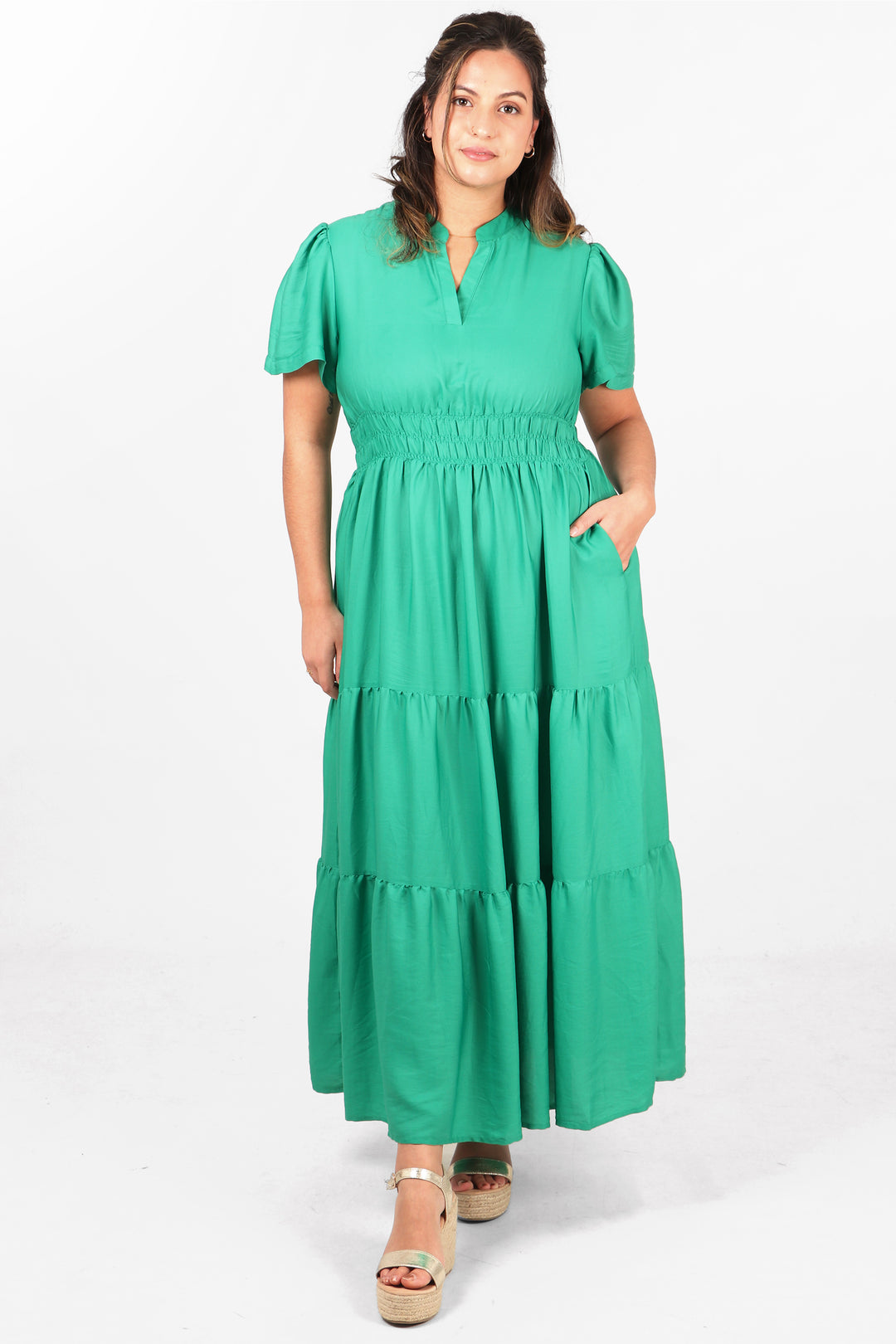 model wearing a plain green maxi dress with short sleeves, smocked waist and grandad collar