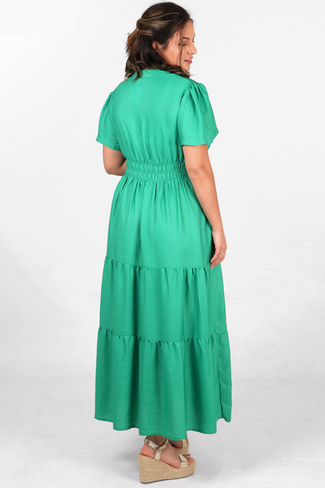 model showing the back of the dress, highlighting the elasticated waist and tiered design