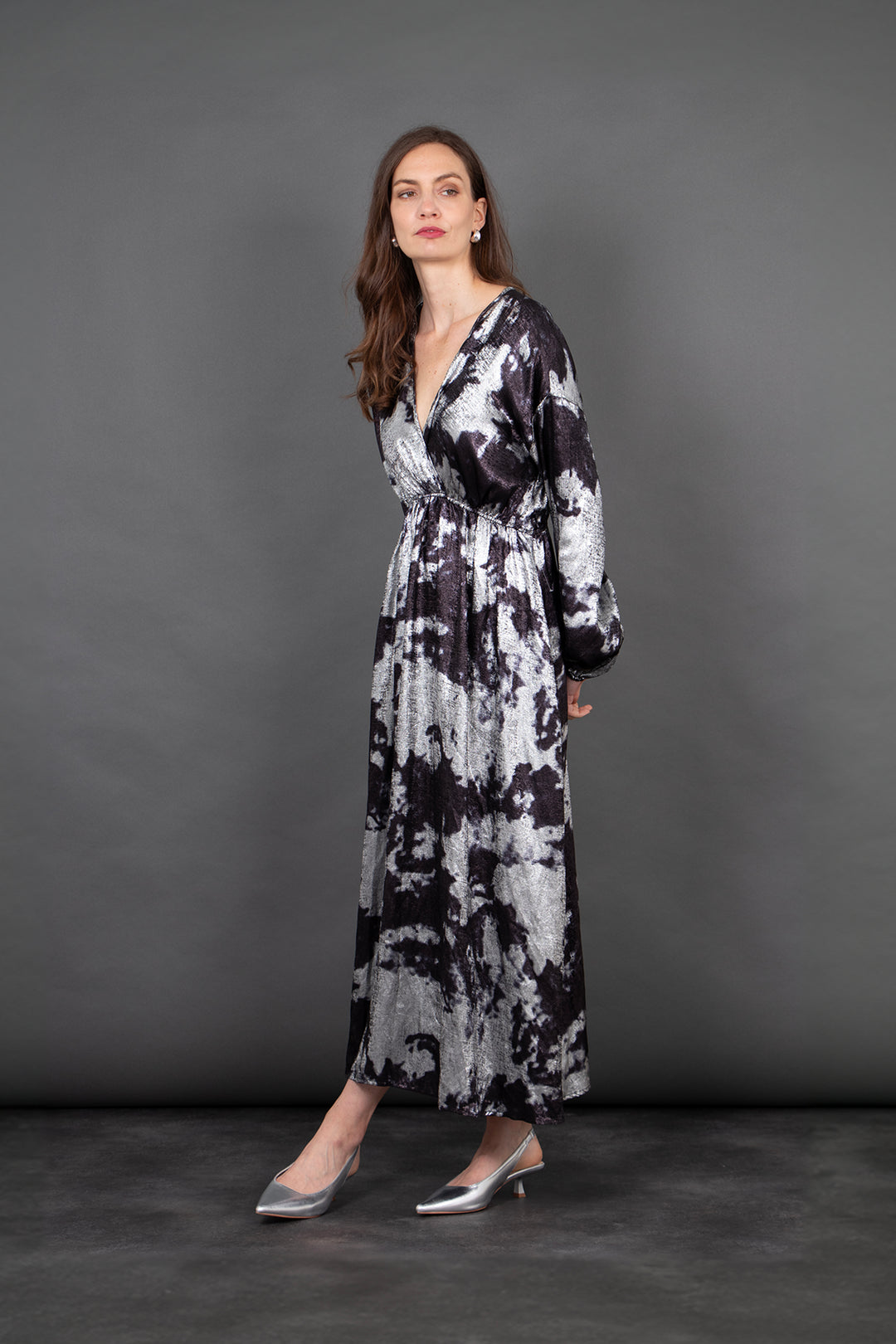 model wearing a long sleeve grey and black paint splash pattern maxi dress with a v-neck