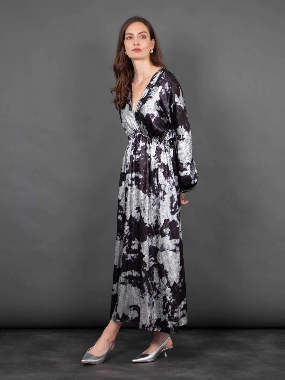 model wearing a long sleeve grey and black paint splash pattern maxi dress with a v-neck