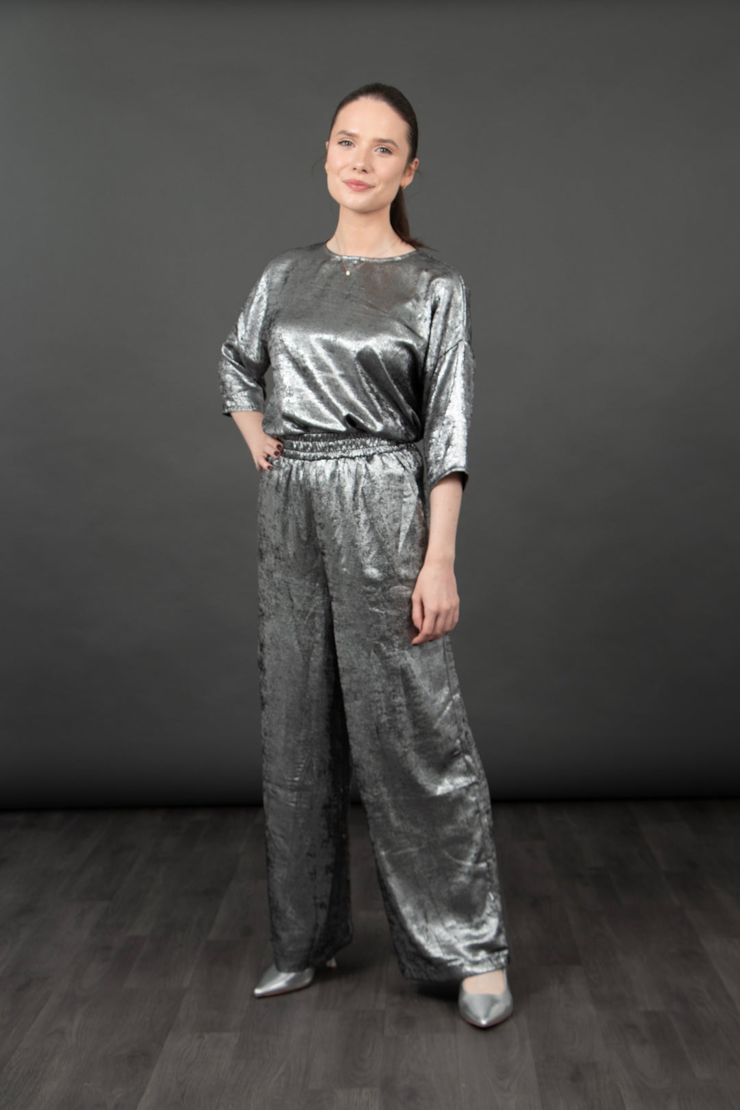 model showing the metallic silver trousers paired with a matching metallic silver top