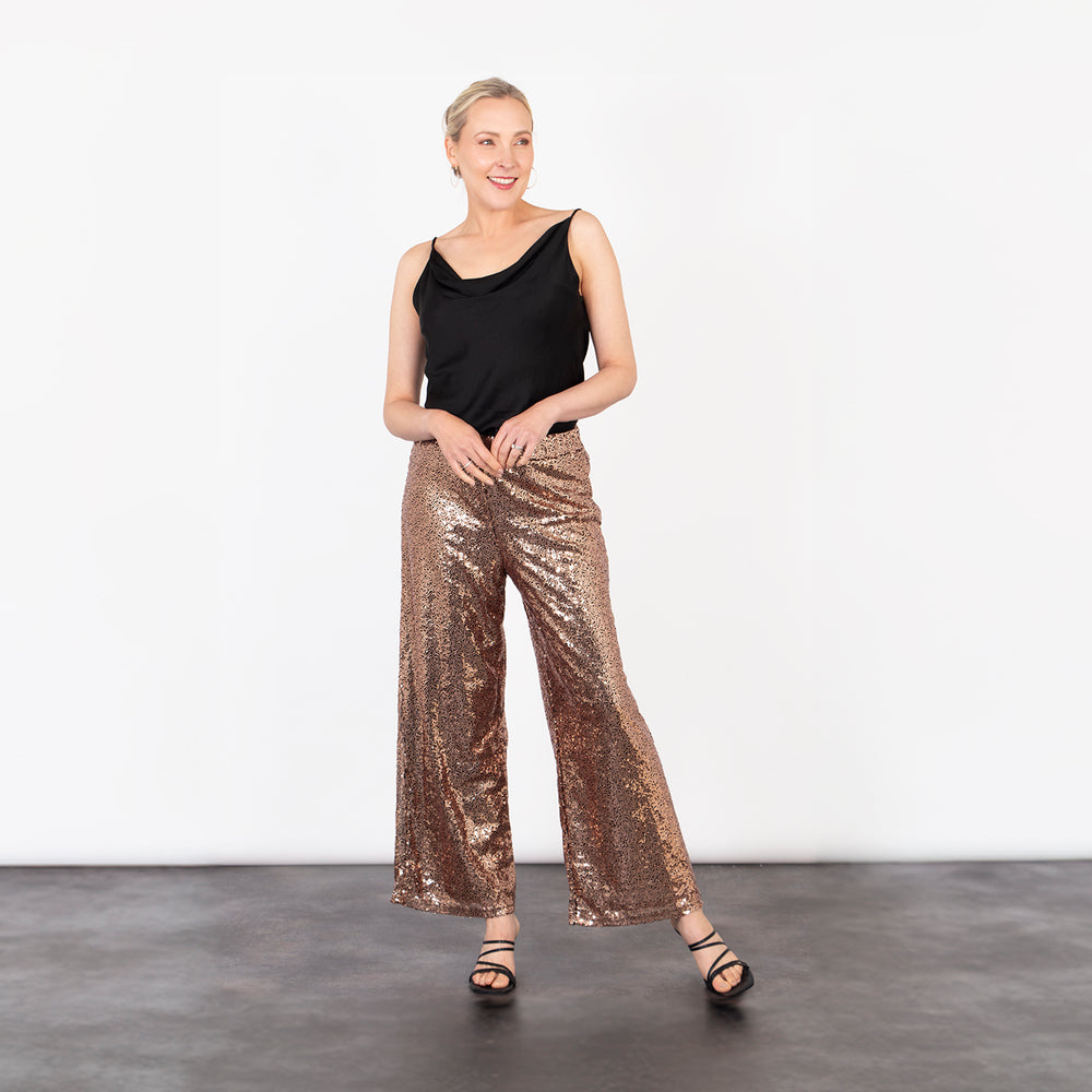 model wearing bronze sequin sparkly wide leg trousers