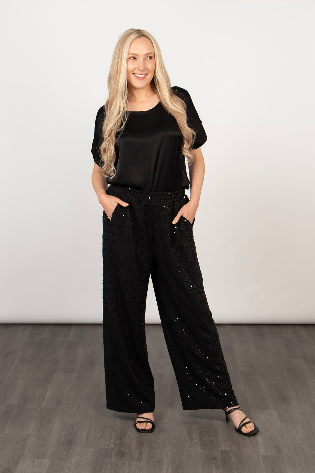 model showing that the black sequin trousers have pockets