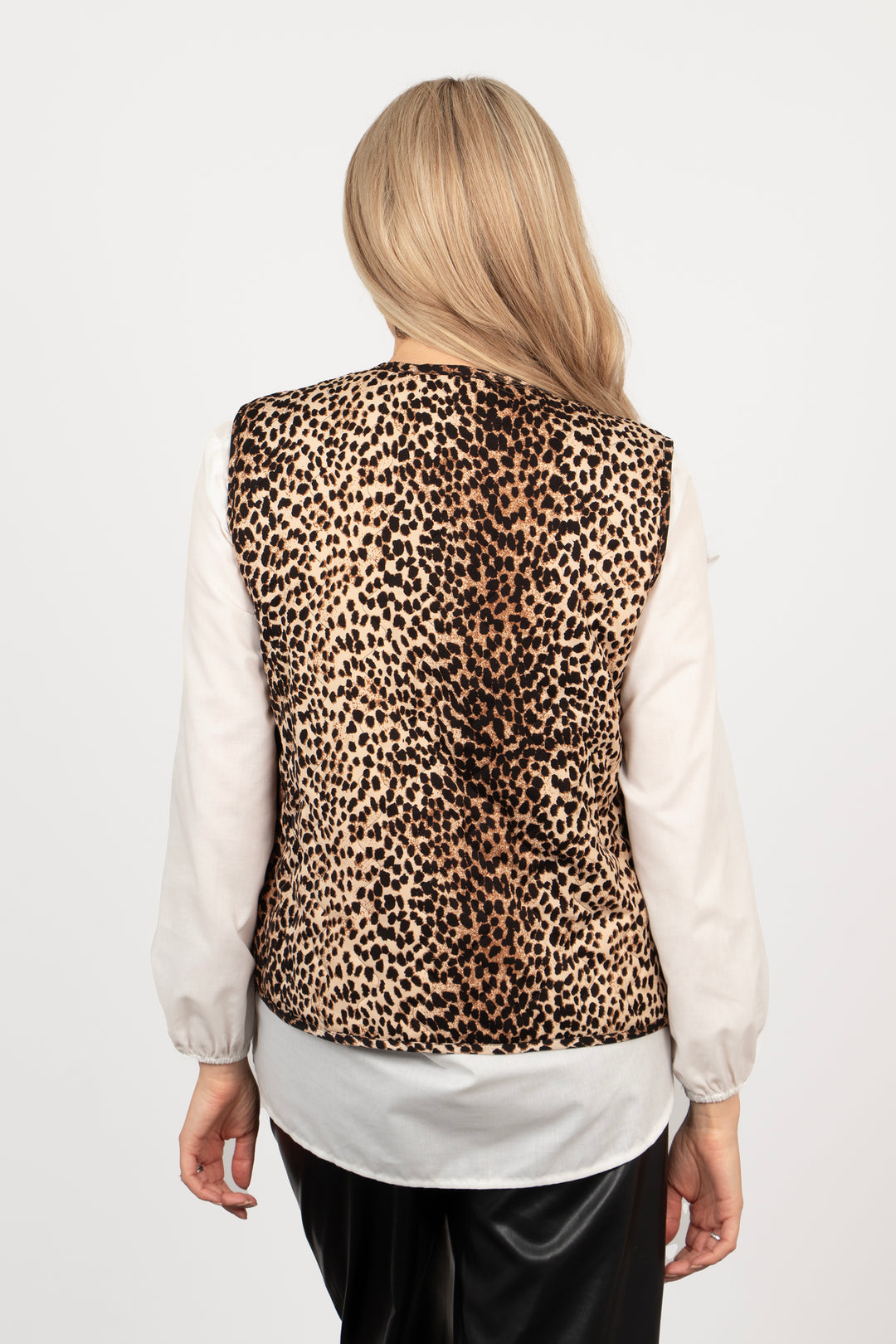 model showing the back of the waistcoat, the neutral leopard print pattern is all over the design.