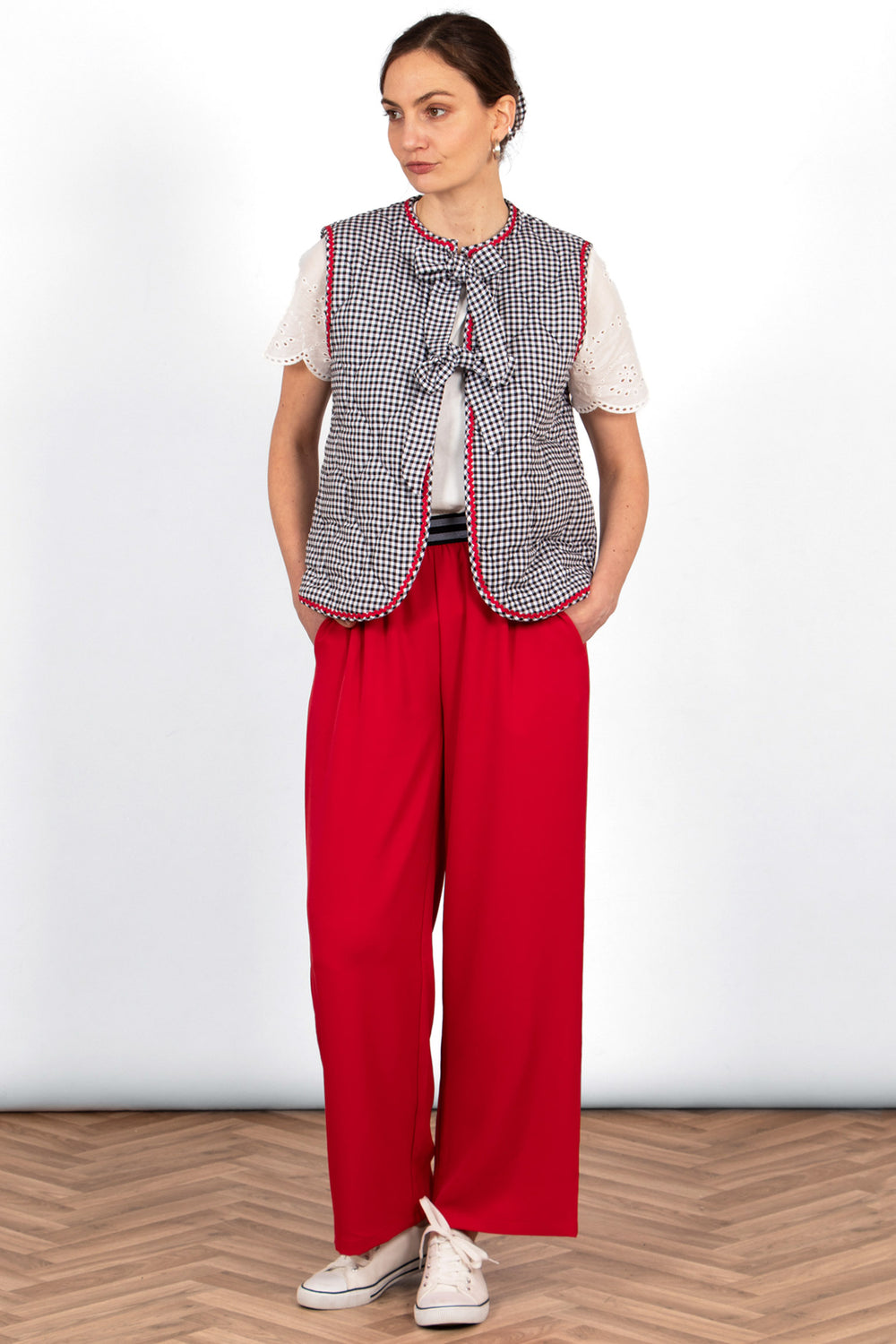 noa-quilted-gilet-black-gingham-styled-with-red-trousers-white-trainers