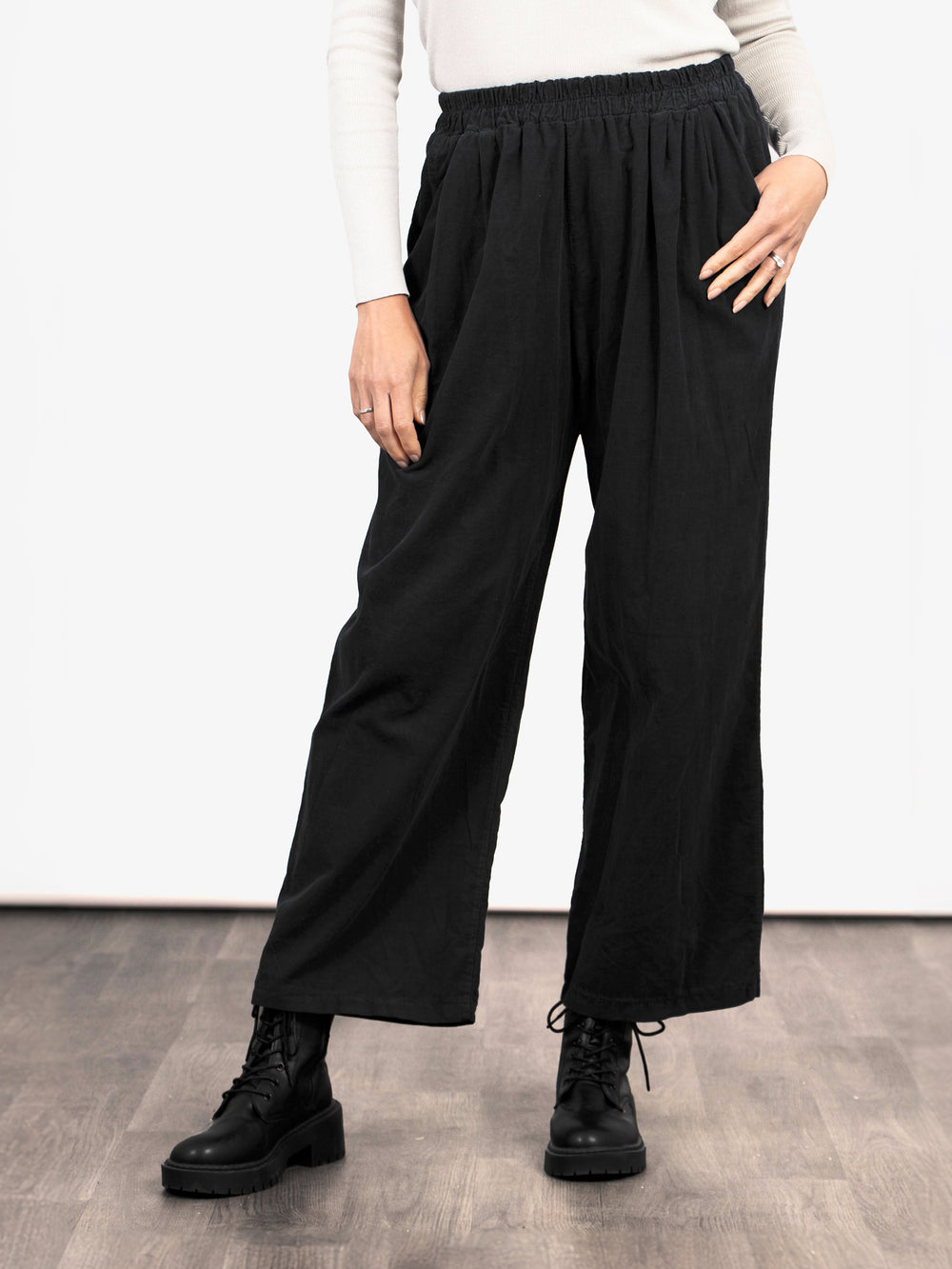 model wearing black cropped wide leg trousers