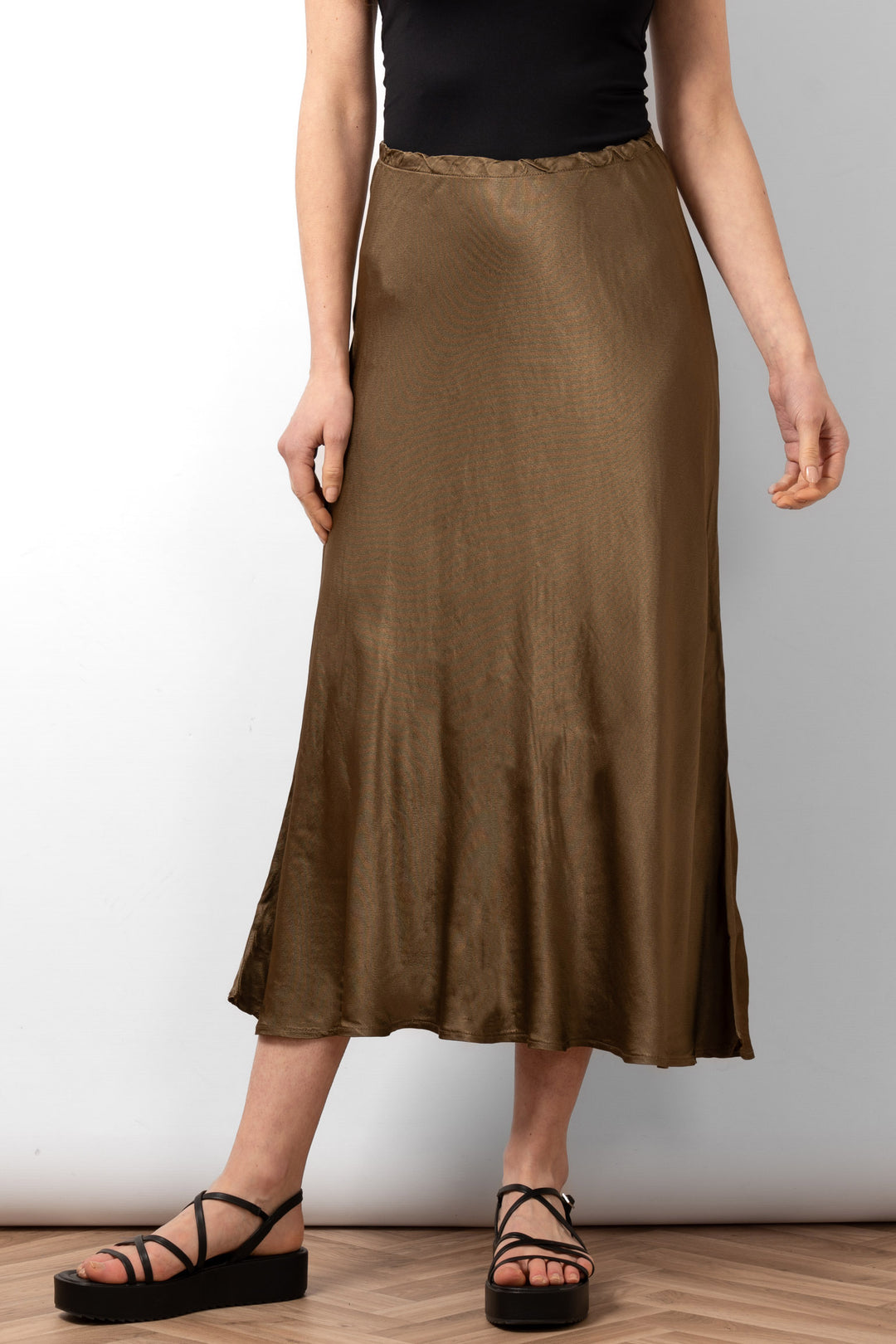 cassie-midi-slip-skirt-khaki-bias-cut-elasticated-waist-worn-on-model