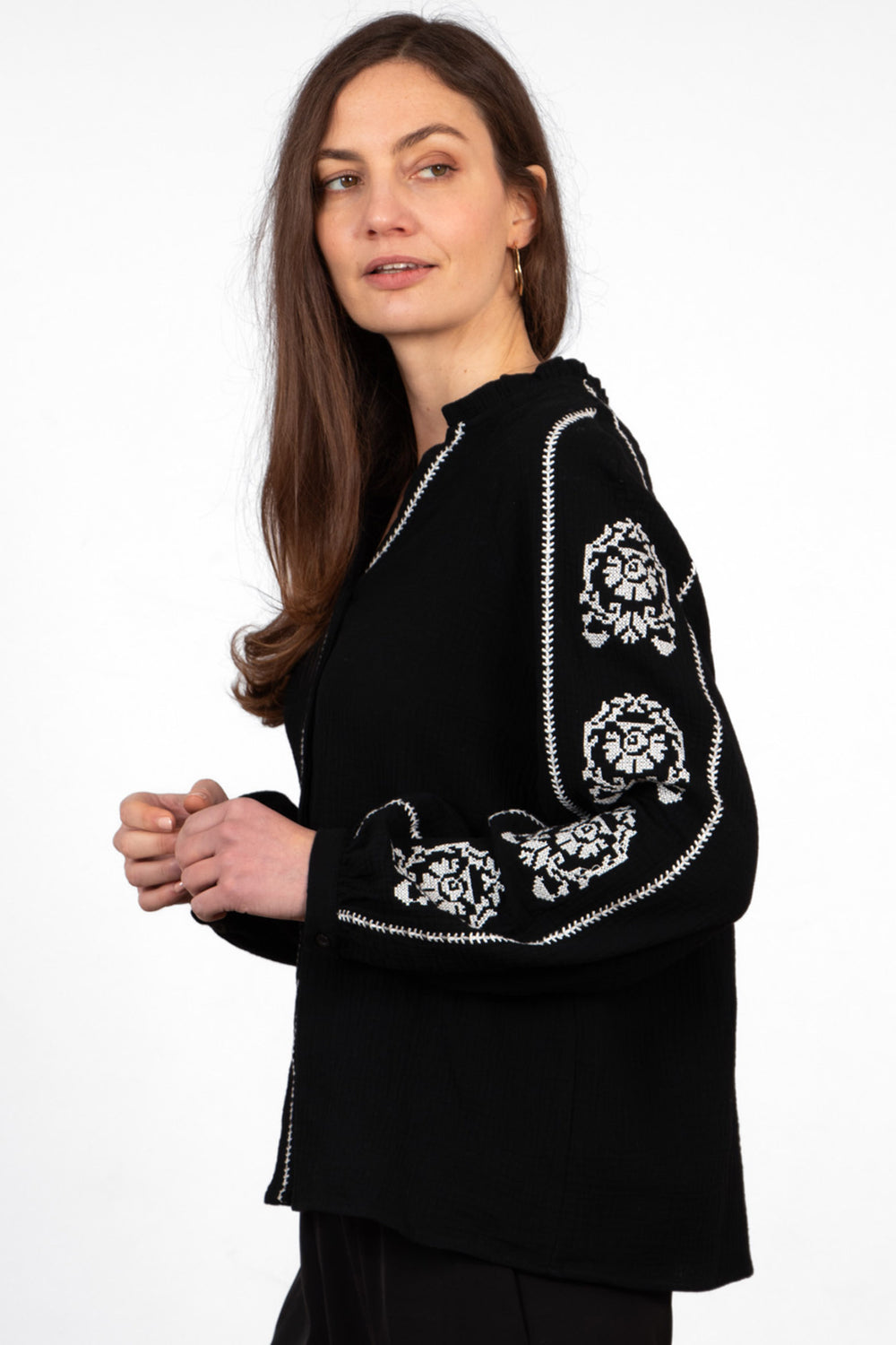 edie-v-neck-button-down-cotton-shirt-black-floral-embroidery-side-view-white-flower-stitched-pattern