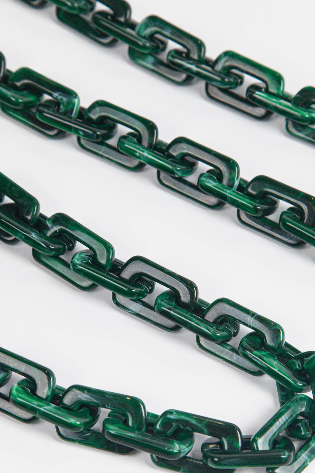 close up of the dark green square link acrylic bag strap