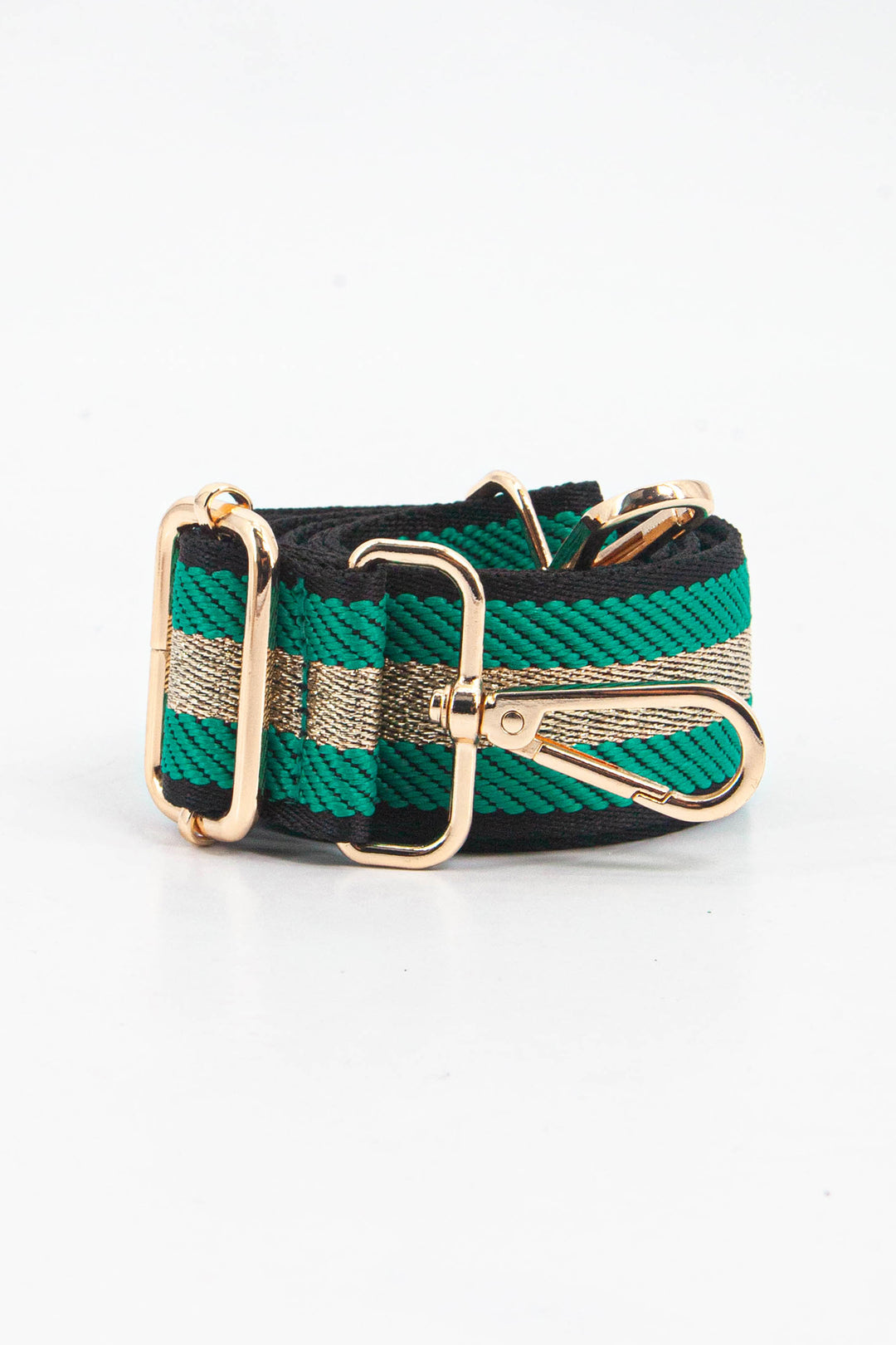 showing the bag strap coiled around itself, the green and gold glitter stripe pattern woven design is prominent , the gold hardware is shown in close up