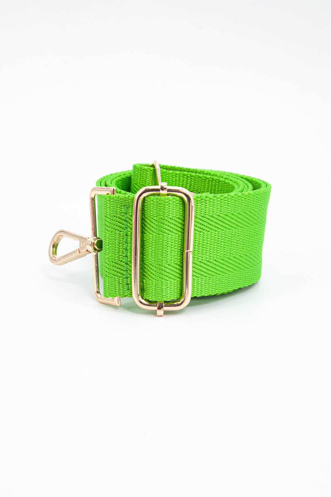 close up of the adjustable bag strap, showing the gold buckle and clip on attachments