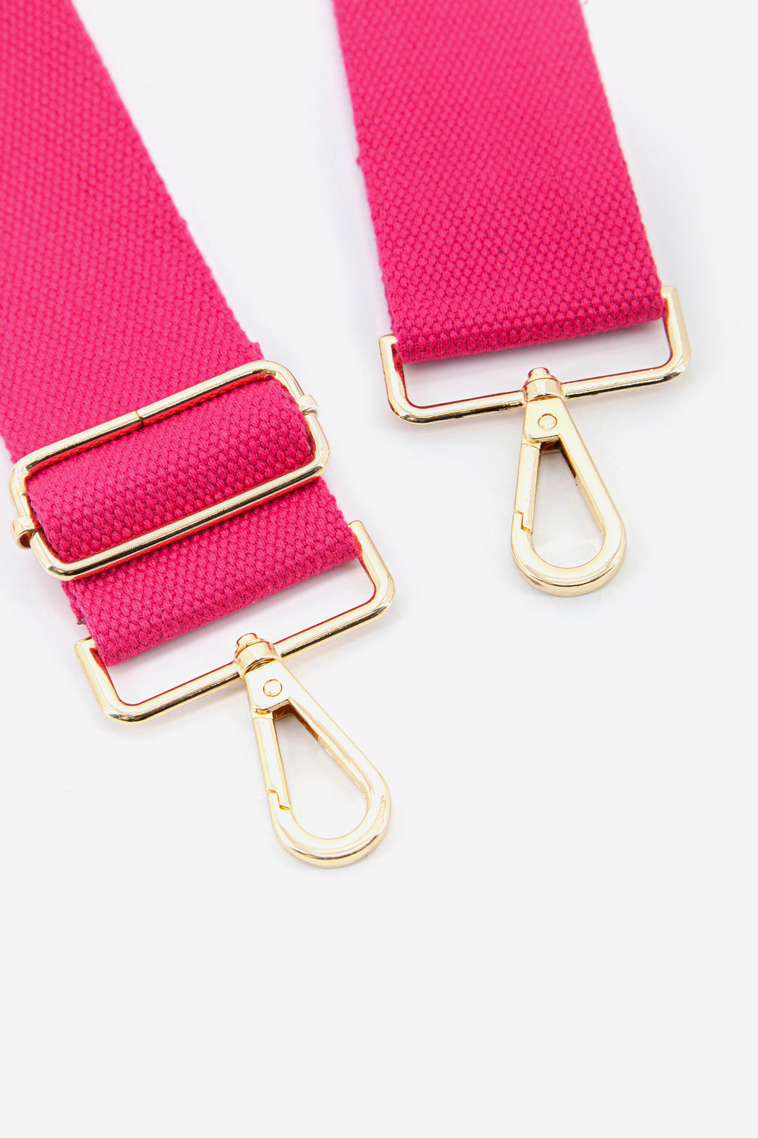 close up of the gold clip on snap hook attachments and vibrant pink colour