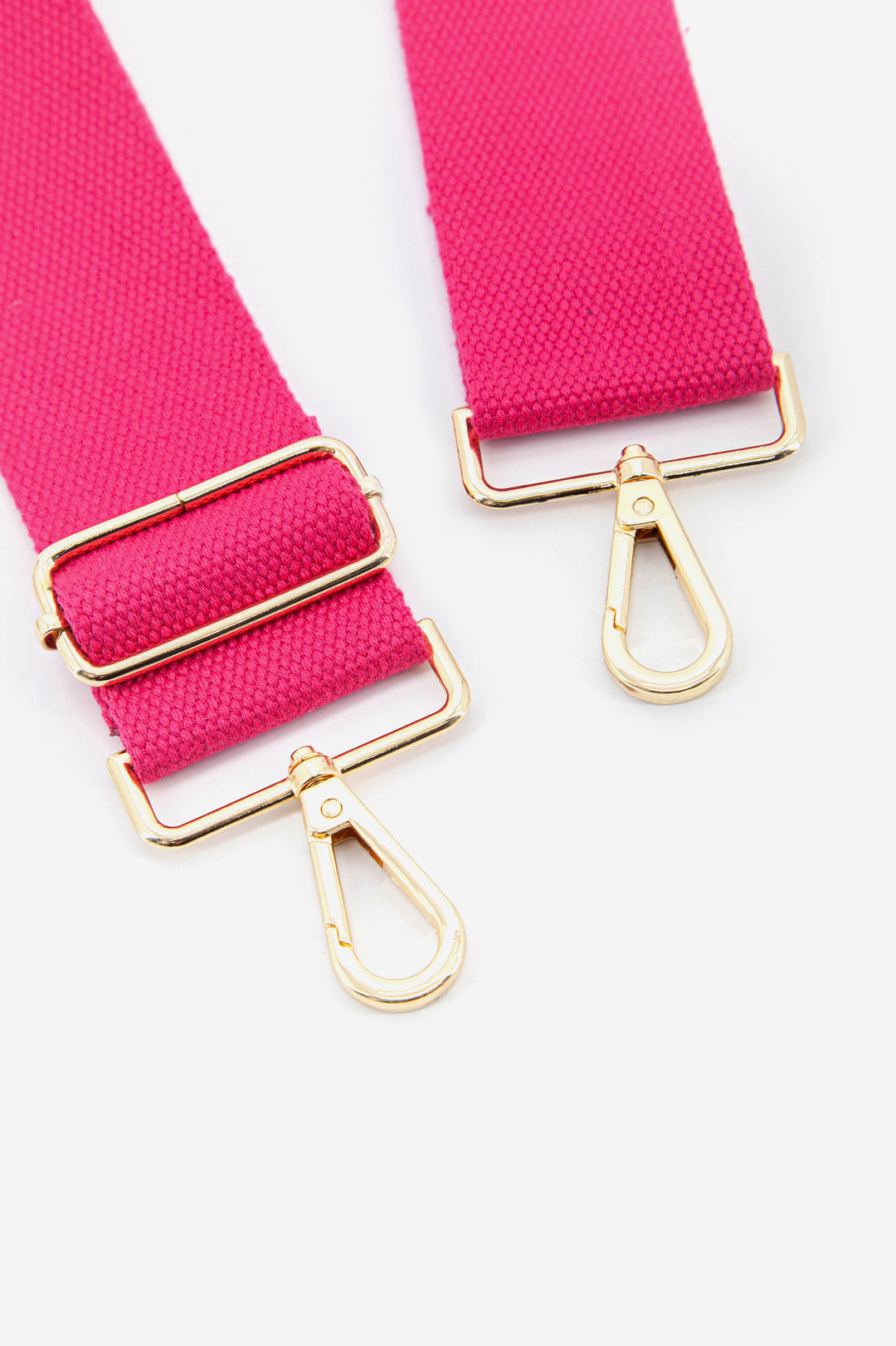 close up of the gold clip on snap hook attachments and vibrant pink colour
