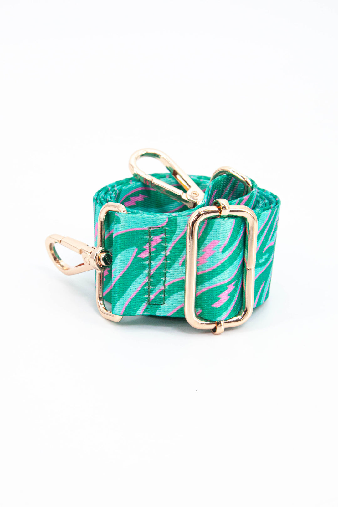 close up of the green and pink zebra and lightning bolt pattern bag strap